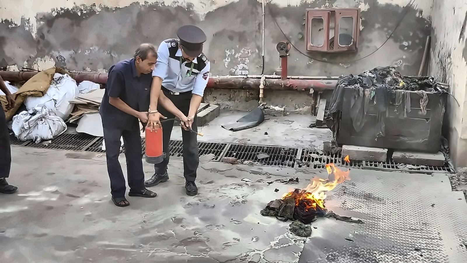 DGuardian staff practicing fire extinguisher use during safety training
